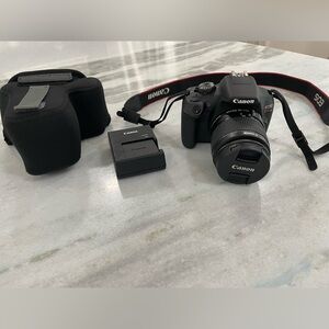 Canon Rebel camera with case and battery charger
